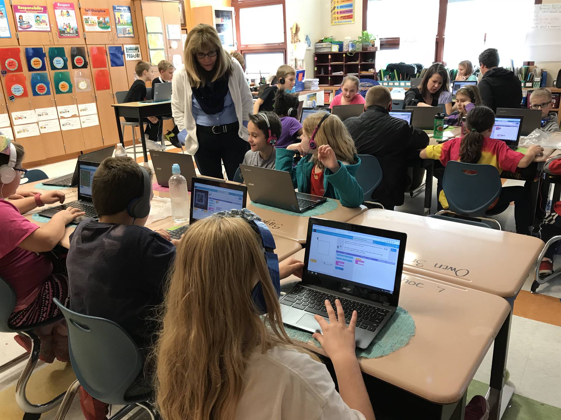 Elementary students work on coding.