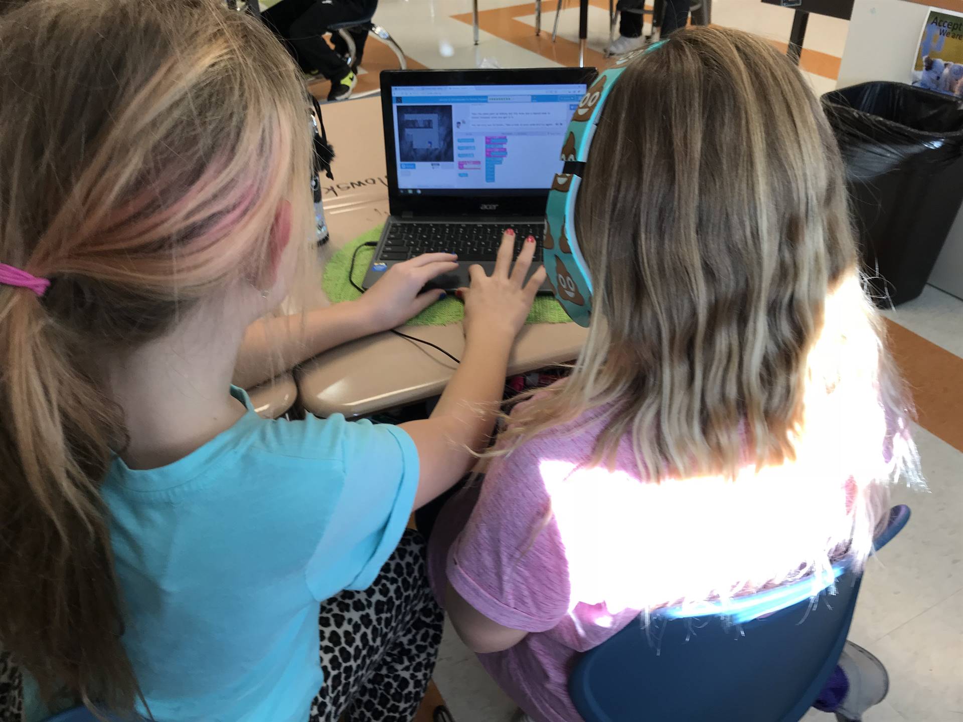 Students collaborate while learning to code.